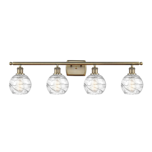 Innovations Athens Deco Swirl 36in 4-Light Bath Vanity Light | Industrial Antique Brass and Clear Glass | Bathroom Vanity | Model 516-4W-AB-G1213-6CL