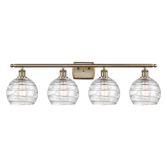 Innovations Athens Deco Swirl 38in 4-Light Bath Vanity Light | Industrial Antique Brass Steel and Clear Deco Swirl Glass | Model 516-4W-AB-G1213-8CL