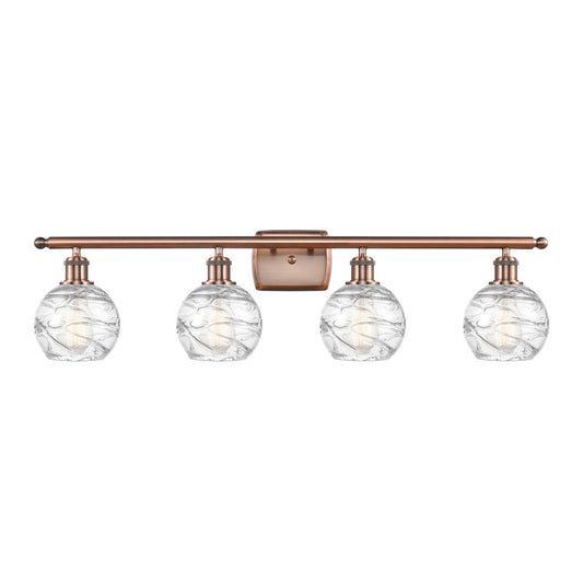 Innovations Athens Deco Swirl 36in 4-Light Bath Vanity Light | Industrial Antique Copper Steel and Clear Glass | Bathroom | Model 516-4W-AC-G1213-6CL