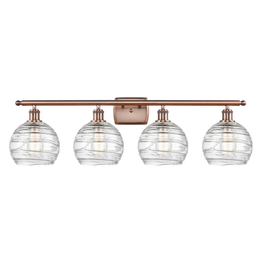 Innovations Athens Deco Swirl 38in 4-Light Bath Vanity Light | Industrial Antique Copper and Clear Deco Swirl Glass | Bathroom | Model 516-4W-AC-G1213-8CL