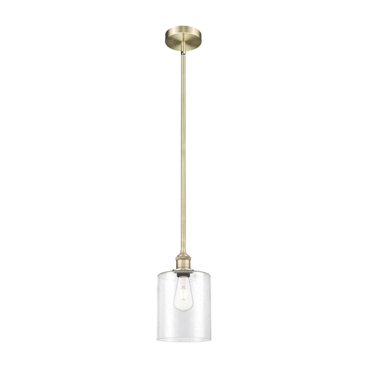 Innovations Paladin 7in 1-Light Mini Pendant | Farmhouse Antique Brass Steel and Seedy Glass Cylinder | Kitchen Island & Dining | Model 616-1S-AB-G4424-7