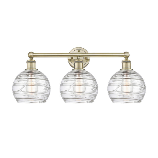 Innovations Athens Deco Swirl 26in 3-Light Bath Vanity Light | Industrial Antique Brass and Clear Deco Swirl Glass | Bathroom | Model 616-3W-AB-G1213-8CL