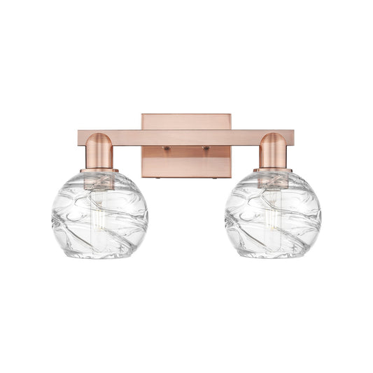 Innovations Athens Deco Swirl 16.88in 2-Light Bath Vanity Light | Industrial Antique Copper Steel and Clear Glass | Bathroom | Model 716-2W-AC-G1213-6CL