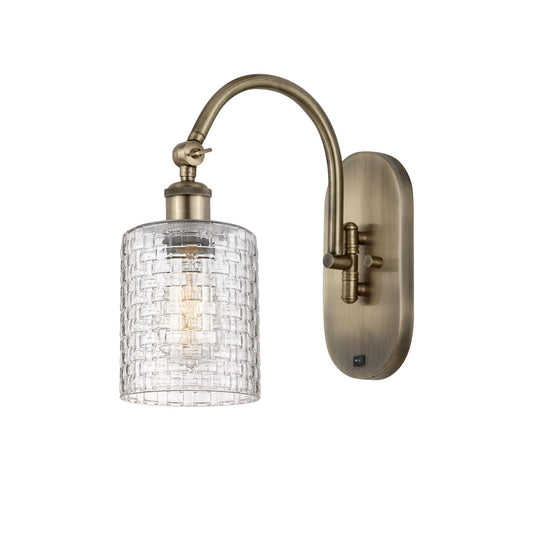 Innovations Cobbleskill 5in 1-Light Wall Sconce | Industrial Antique Brass Steel and Clear Basket Weave Glass | Hallway & | Model 918-1W-AB-G112C-5CL
